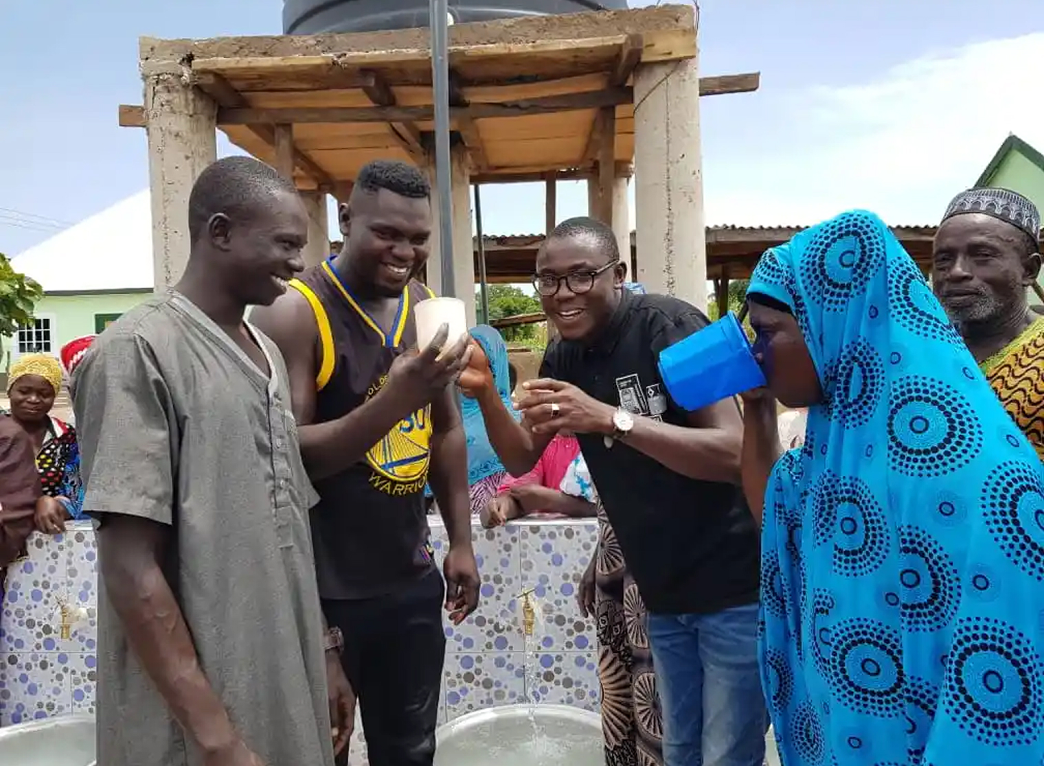 A community member using a hand pump to draw fresh clean water at the Ngarong well site